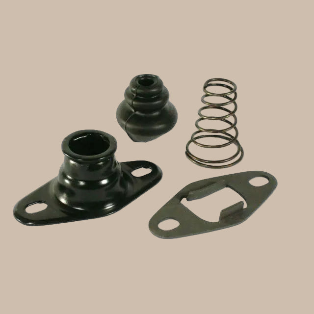 Set of mechanical components including black balls, spring, and metal plate